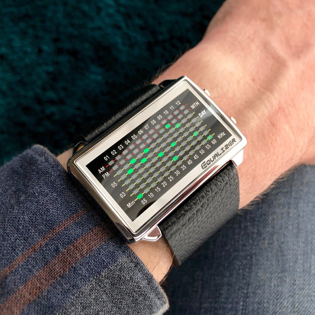 https://tokyoflash.com/cdn/shop/products/equalizer-high-frequency-lcd-watch-tokyoflash-japan-silver-case-black-leather-strap-green-lcd-on-wrist-01_2048x.jpg?v=1682441466